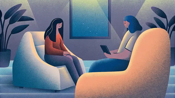 Deux femmes assises face à face dans des fauteuils, une séance d'accompagnement en développement personnel